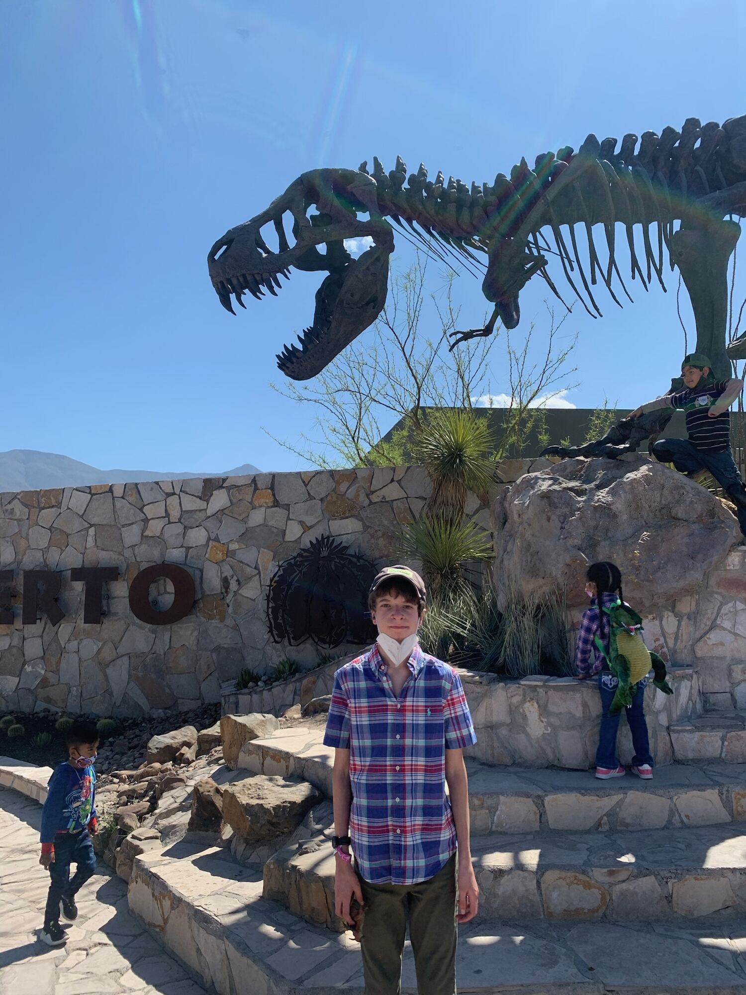Hudson at the museum entrance, under the Tyrannosaurus skeleton.